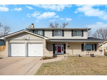 Charming two-story home with brick accents, a two-car garage, and a well-maintained front yard at 3257 S Geneva St, Denver, CO 80231