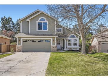Charming two-story home with well-manicured lawn and a two car garage at 746 Poppywood Dr, Highlands Ranch, CO 80126