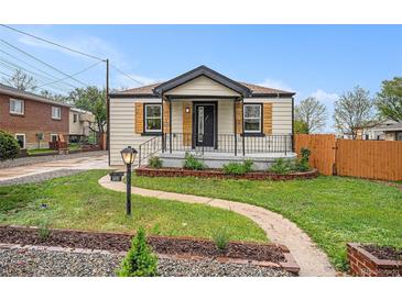 Charming single-story home with landscaped front yard, walkway, and welcoming porch at 5491 Lowell Blvd, Denver, CO 80221