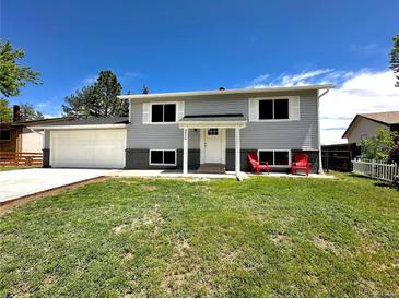 Charming home featuring a well-manicured lawn, two-car garage and relaxing front porch at 8820 Cody St, Broomfield, CO 80021