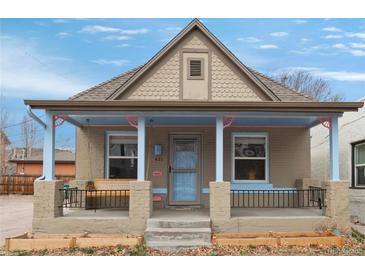 Charming home exterior with a porch swing and colorful accents at 421 Elati St, Denver, CO 80204