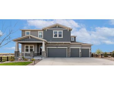 Beautiful two-story home featuring a three-car garage and charming stone accents on the facade at 3128 Bivouac Pt, Castle Rock, CO 80108