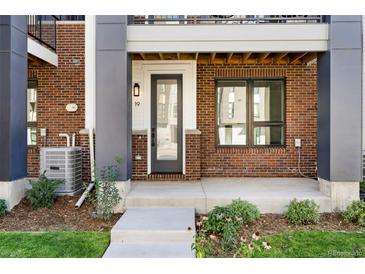 Brick front exterior with private entrance and small patio at 8260 E 36Th Ave # 29, Denver, CO 80238