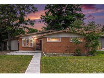 Charming single-story brick home with a well-maintained lawn and a tidy sidewalk leading to the front door at 400 W Midway Blvd, Broomfield, CO 80020