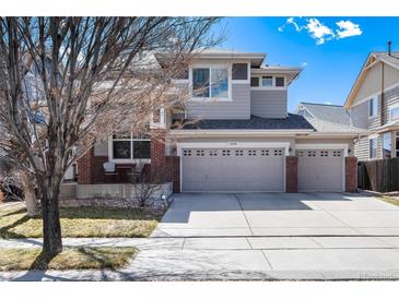 Charming two-story home with a three-car garage and inviting front porch at 16240 E 119Th Ave, Commerce City, CO 80022