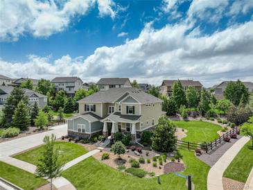 Charming two-story home with beautiful landscaping and a well-maintained lawn at 23451 E Rockinghorse Pkwy, Aurora, CO 80016