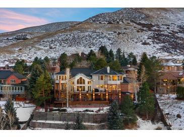 Stunning home with expansive deck nestled against a picturesque mountain backdrop at 15895 W Bayaud Dr, Golden, CO 80401