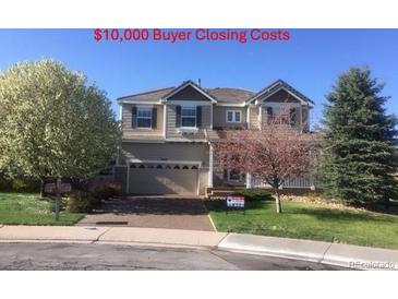 Charming two-story home with a two-car garage and mature trees in the front yard at 3480 Spruce Dell Ct, Castle Rock, CO 80109