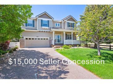 Charming two-story home with a large front lawn, attached two car garage, and a cozy front porch at 3480 Spruce Dell Ct, Castle Rock, CO 80109
