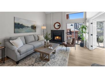 Inviting living room with a cozy fireplace and lots of natural light at 4899 S Dudley St # 19, Littleton, CO 80123