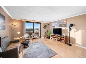 Cozy living room with large windows offering great views and a comfortable seating arrangement at 1301 Speer Blvd # 410, Denver, CO 80204