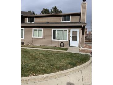 Tan two-story home with small lawn and driveway at 841 Crisman Dr # 12, Longmont, CO 80501