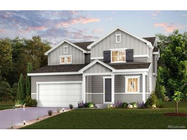 Charming two-story home with a well-manicured lawn and classic architectural details at 12354 E 101St Dr, Commerce City, CO 80022