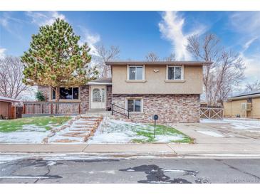 Ranch style home with stone accents and a landscaped front yard at 4865 Scranton Ct, Denver, CO 80239