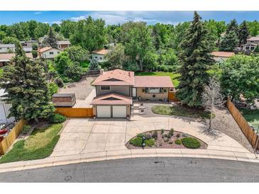 Aerial view of a two-story house with a spacious driveway and a well-maintained, lush green yard at 2380 W 105Th Pl, Northglenn, CO 80234
