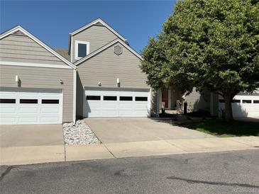 Charming home featuring a two-car garage, mature landscaping, and a well-maintained yard on a sunny day at 15555 E 40Th Ave # 11, Denver, CO 80239