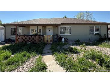 Charming single-story home with a covered porch and mature landscaping at 1151 Revere St, Aurora, CO 80011