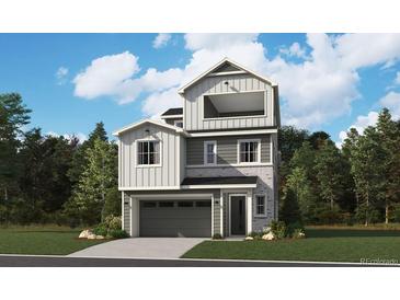 Charming gray two-story home featuring a gray garage door, covered porch and upstairs balcony at 8462 Eagle River St, Littleton, CO 80125