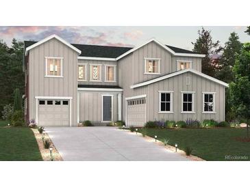 Charming two-story home featuring a two-car garage, a well-manicured lawn, and beautiful landscaping at 1699 Morgan Dr, Erie, CO 80516