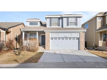 Two-story home featuring a two-car garage and light gray siding at 12366 Nate Cir, Parker, CO 80134