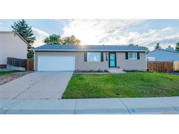 Charming ranch style home with well-maintained lawn, attached garage and inviting curb appeal at 6393 S Johnson St, Littleton, CO 80123