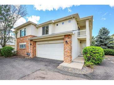 Inviting two-story home with a two-car garage and brick accents, perfect for comfortable living at 1311 S Kingston St, Aurora, CO 80012