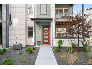 Charming front entrance with a red door, wreath, and well-maintained landscaping at 6792 Navajo Way, Denver, CO 80221