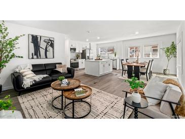 Bright living room open to the kitchen with modern furniture, wood floors, and abundant natural light at 1858 S Lincoln St, Denver, CO 80210