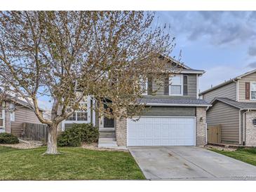 Charming two-story home with a well-maintained lawn and a two car attached garage at 3268 E 136Th Pl, Thornton, CO 80602