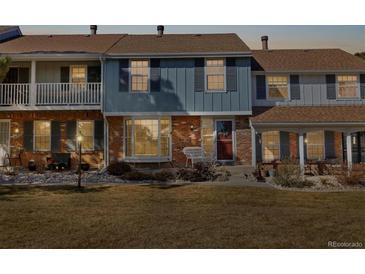 Charming townhome with a combination brick and siding facade and front yard at 2540 E Geddes Pl, Centennial, CO 80122