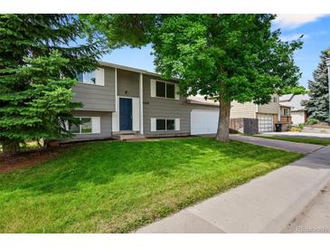 Charming two-story home with a well-maintained lawn and mature tree in a desirable neighborhood at 9196 W Maplewood Ave, Littleton, CO 80123