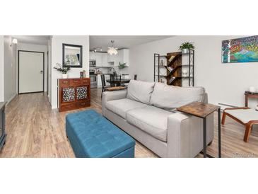 Bright living room showcasing an open floor plan, hardwood floors, and stylish decor, creating an inviting atmosphere at 6940 E Girard Ave # 210, Denver, CO 80224