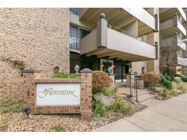 The Florentine building entrance showcasing a well-maintained brick exterior and landscaped entrance at 700 N Washington St # 1104, Denver, CO 80203