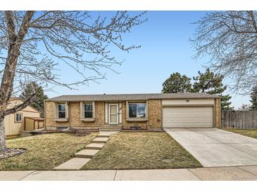Charming brick home with a well-maintained lawn and attached two-car garage at 4828 S Nucla Way, Aurora, CO 80015