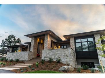 Stunning exterior view of modern stone home with manicured landscaping at 5429 S Kearney St, Greenwood Village, CO 80111