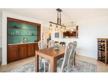 Open dining room features a built-in bar and modern light fixture, perfect for entertaining guests at 1029 E 8Th Ave # 1302, Denver, CO 80218