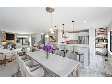 Bright living room featuring an open floor plan that connects to a modern kitchen with stainless steel appliances at 8755 W Cornell Ave # 14-5, Lakewood, CO 80227