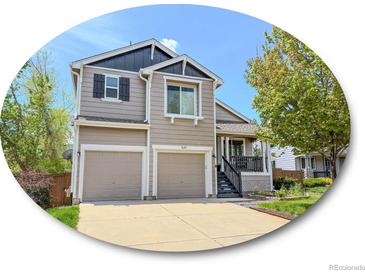 Charming two-story home with a two-car garage and well-manicured lawn at 9687 Timbervale Ct, Highlands Ranch, CO 80129