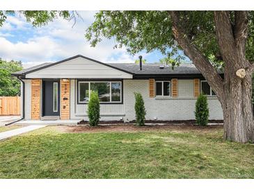 Charming, newly renovated single-story home with modern wood and painted brick exterior at 530 Everett St, Lakewood, CO 80226