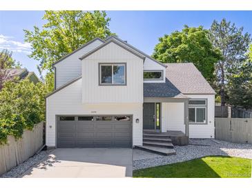 Charming two-story home with gray trim, attached garage, well-kept lawn, and beautiful landscaping at 2640 Overlook Dr, Broomfield, CO 80020