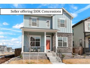 Charming two-story home featuring a cozy front porch and stylish stone accents, perfect for modern living at 21209 E 62Nd Ave, Aurora, CO 80019