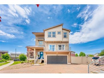 Beautiful multi-story home with a modern design, attached garage, and a well-maintained brick driveway at 18651 E 53Rd Ave, Denver, CO 80249