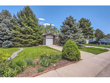 Charming home featuring a well-maintained lawn, mature trees, and inviting curb appeal at 2208 Emery St, Longmont, CO 80501