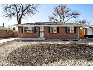 Charming brick home with a well-maintained lawn and lovely landscaping at 7891 Maria St, Westminster, CO 80030