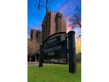 Brick high rise building near Washington Park with mature landscaping and a dramatic sunset view behind the building at 480 S Marion Pkwy # 1202, Denver, CO 80209