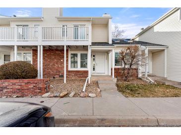 Brick townhouse exterior with small front yard and walkway at 17286 E Ford Dr, Aurora, CO 80017