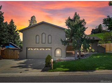Charming brick home with well-manicured lawn and mature trees, perfect for Gathering living at 14418 W Bayaud Ave, Golden, CO 80401