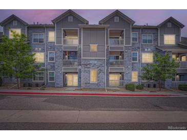 Charming apartment building with grey stone and white trim, offering a modern living space at 1831 S Dunkirk St # 103, Aurora, CO 80017