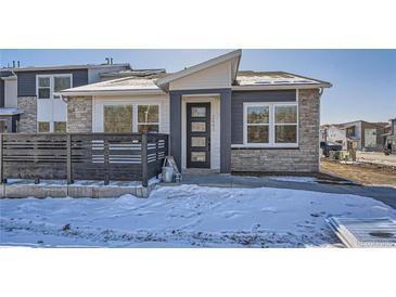 Charming two-story home featuring a modern exterior design with stone accents and a welcoming front entrance at 2491 W 69Th Pl, Denver, CO 80221