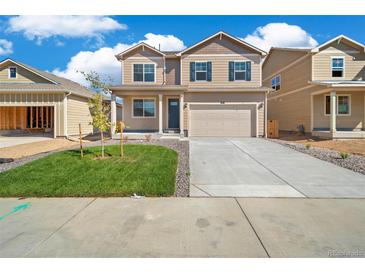 Charming two-story home with a well-maintained lawn and inviting curb appeal at 18813 E 99Th Ave, Commerce City, CO 80022